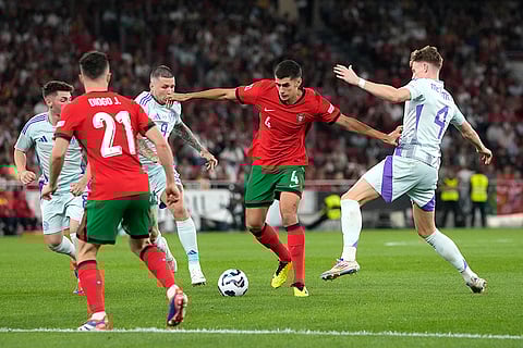 2024–25 UEFA Nations League, Portugal vs Scotland: Portugal's Antonio Silva, second from right, challenges for the ball with Scotland's Scott McTominay, right, and Lyndon Dykes